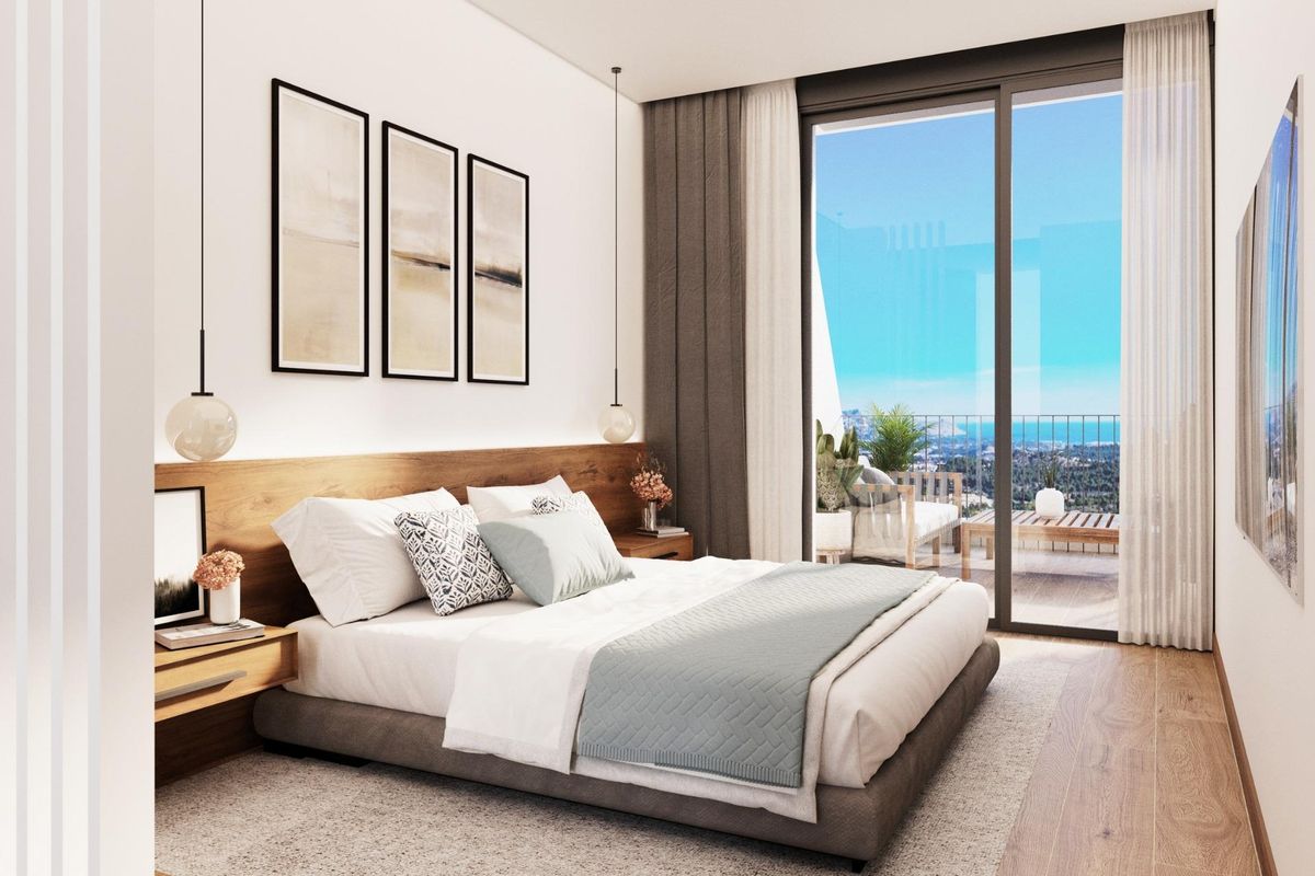 Luxurious bedroom in a Polop villa showcasing modern design and a view of the outdoor area.