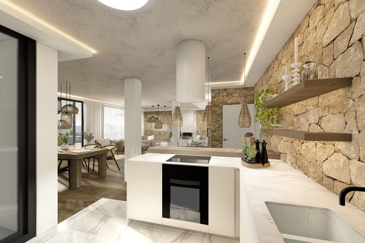 Strakke keuken met moderne apparaten en stenen accenten, onderdeel van een townhouse in Altea.