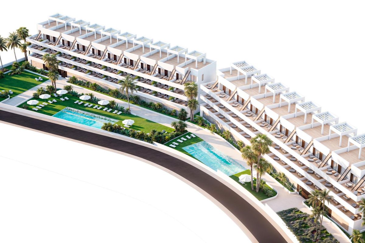 Luchtperspectief van het appartementencomplex in Finestrat, met zwembaden en omliggende groene gebieden.