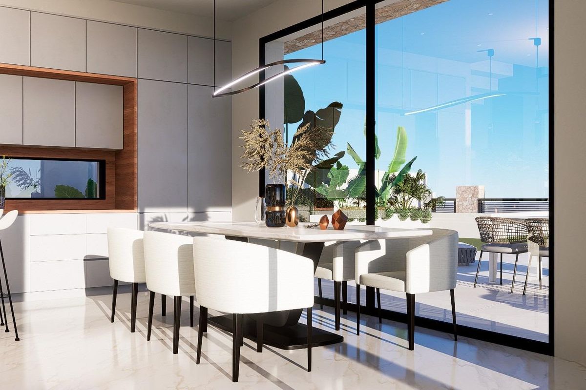 Strakke eetruimte in een 3-slaapkamer villa in Finestrat, met uitzicht op de tuin en moderne meubels.