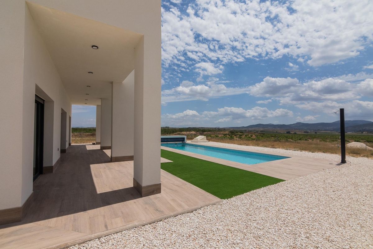 View of the pool and outdoor area from the covered terrace of the villa in Pinoso, Costa Blanca South.