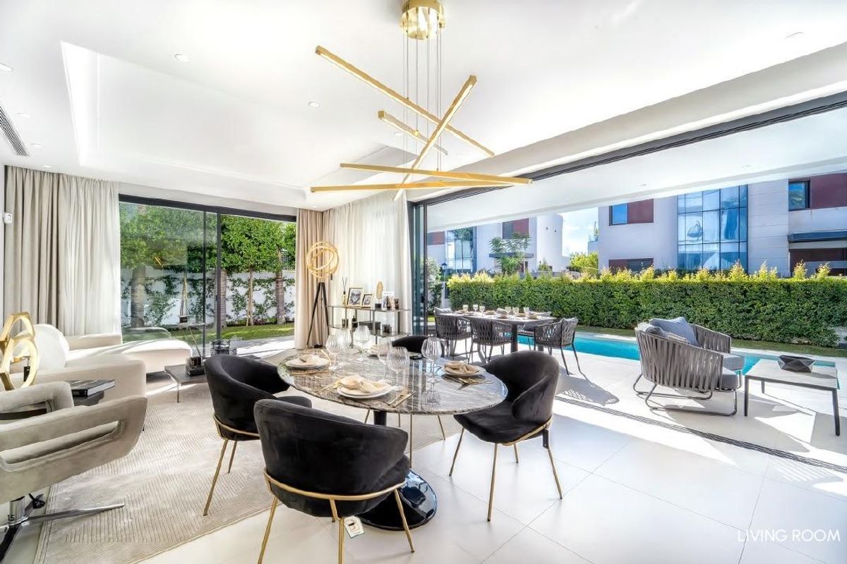 Heldere en moderne woonkamer van de villa, met stijlvolle inrichting en verbinding met de buitenruimte.