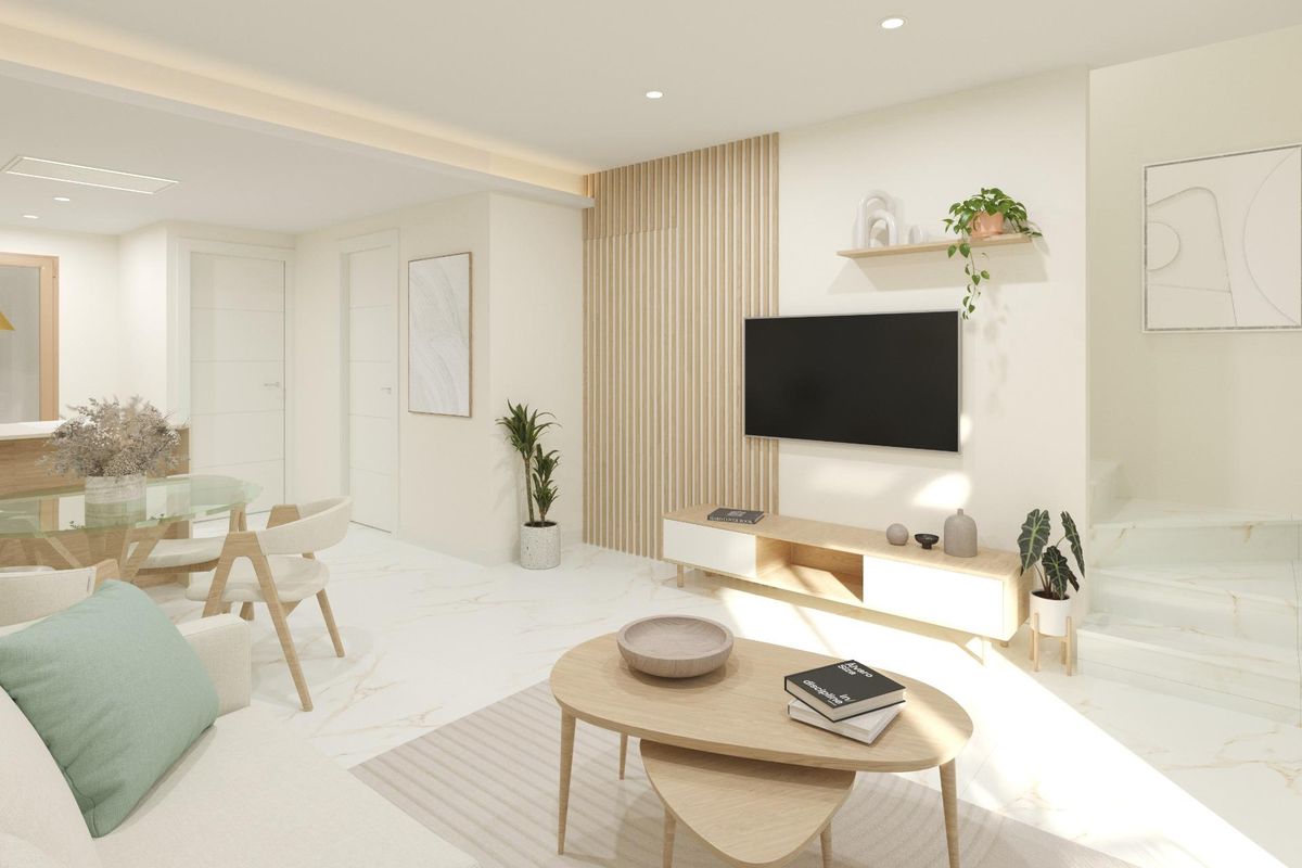 Modern open-plan living area with dining and a view towards the staircase. Dolores townhouse, Costa Blanca South, Spain.