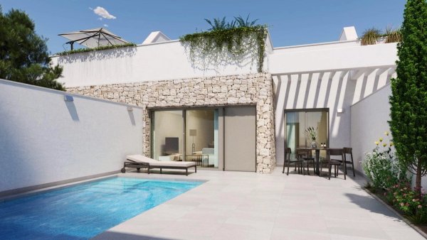 Outdoor terrace with a pool, sun loungers, and seating area in Pilar de La Horadada, Spain.