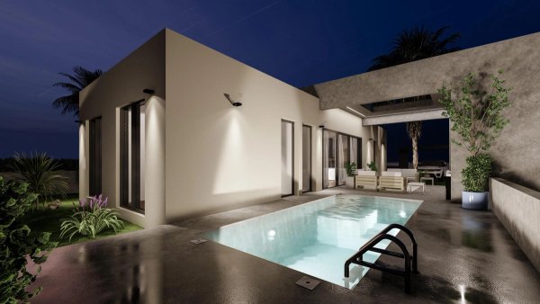 Modern villa exterior with pool at night in Baños y Mendigo, Costa Calida. Relaxed outdoor seating.
