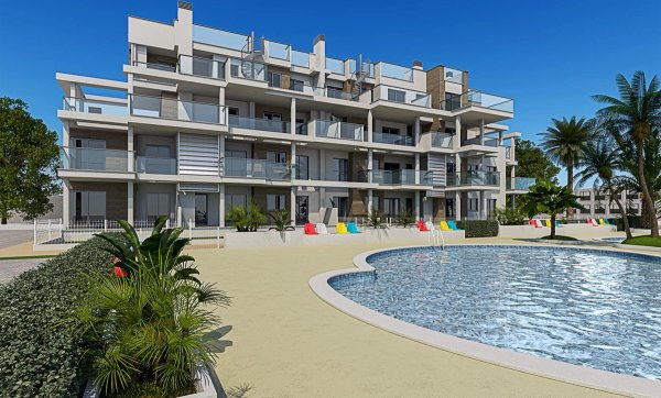 Exterior of a modern apartment building with a pool in Denia, Costa Blanca North. Colorful chairs surround the pool area near palm trees.