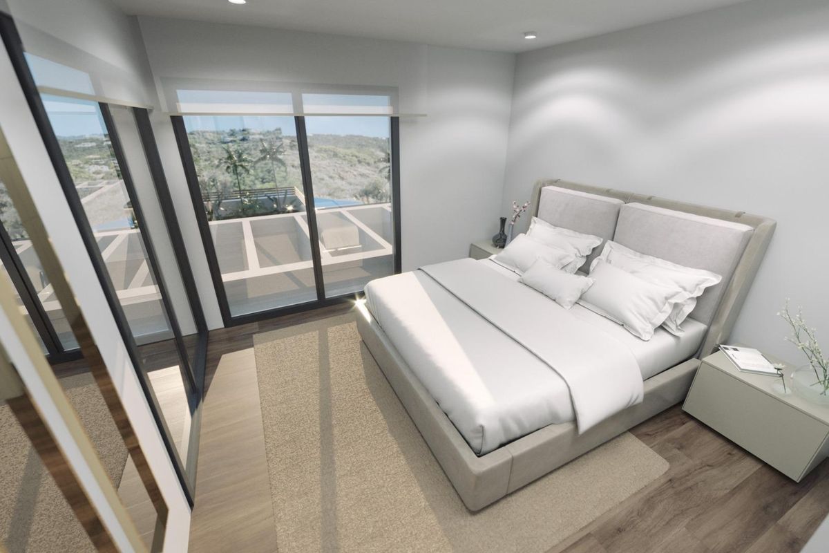 Elegante slaapkamer in een 3-slaapkamer villa in Finestrat, met grote ramen en minimalistisch ontwerp.