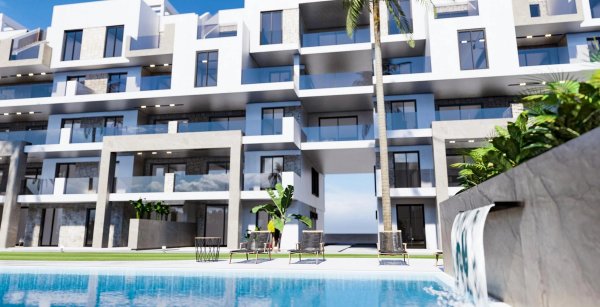 Exterior view of a modern 3-bed apartment complex in Guardamar del Segura, featuring a sleek pool area.