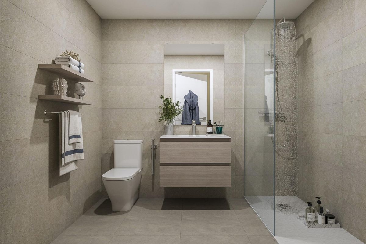 Modern badkamer met stijlvolle armaturen en een glazen douche in een penthouse in Manilva, Costa del Sol.