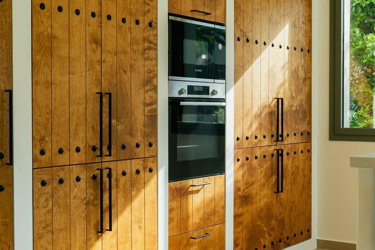 Hedendaagse keuken met houten kasten en moderne apparaten in een 3-slaapkamer villa in Jávea Xàbia.