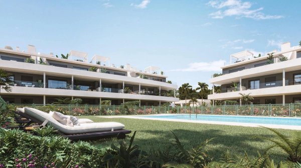 Buitenkant van een modern appartementencomplex met zwembad, tuin en groen in Estepona, Costa del Sol.