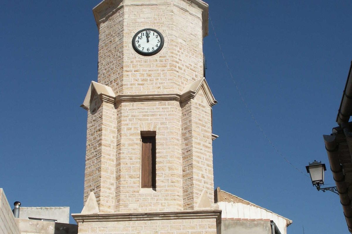 Historic clock tower in Pinoso with traditional architecture, showcasing the town's charm.
