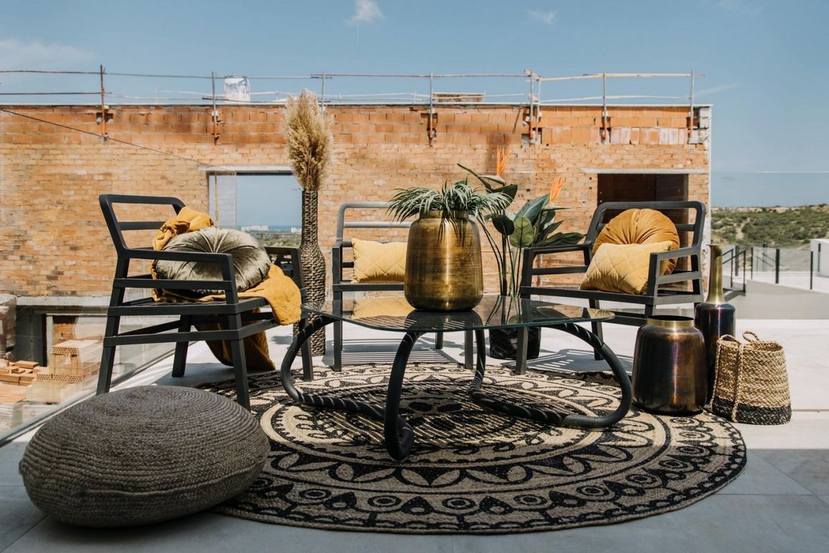 Chique buitenlounge met moderne stoelen en decor, gelegen op het terras van de villa in Rojales.