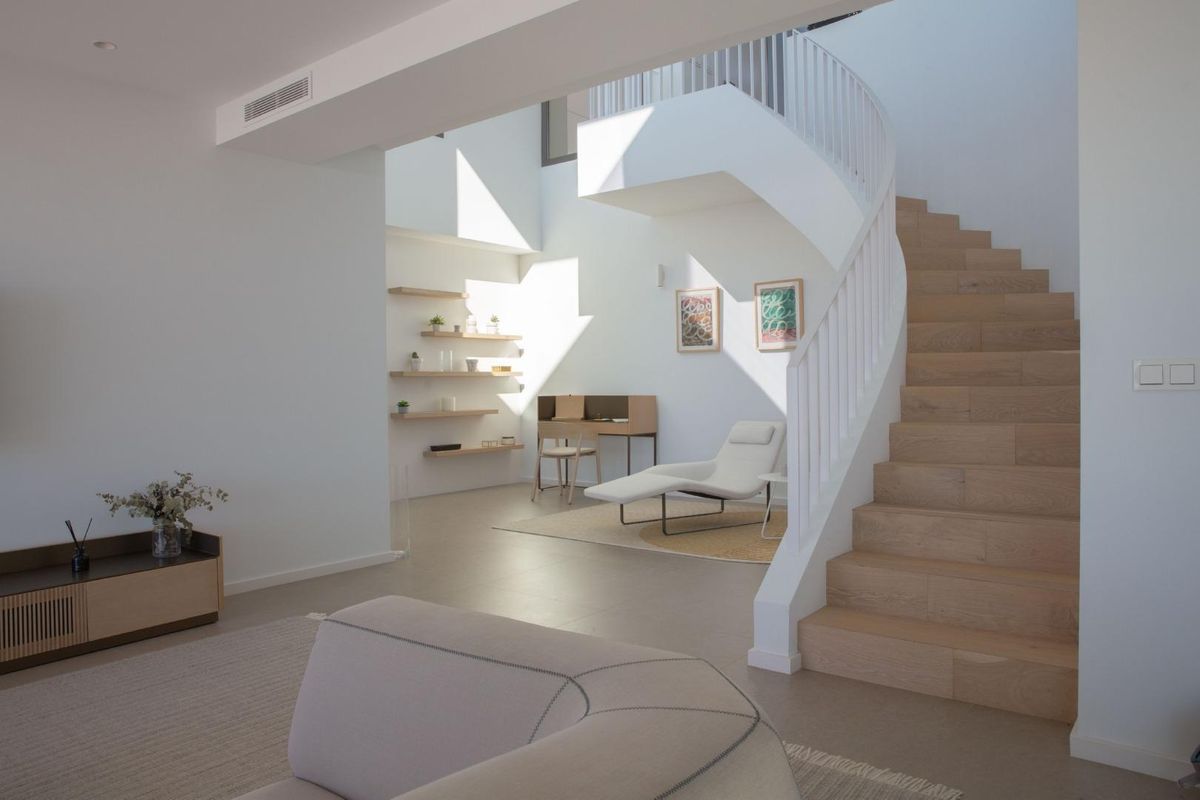 Bright, airy staircase of the villa leading to upper levels, complemented by modern design elements.
