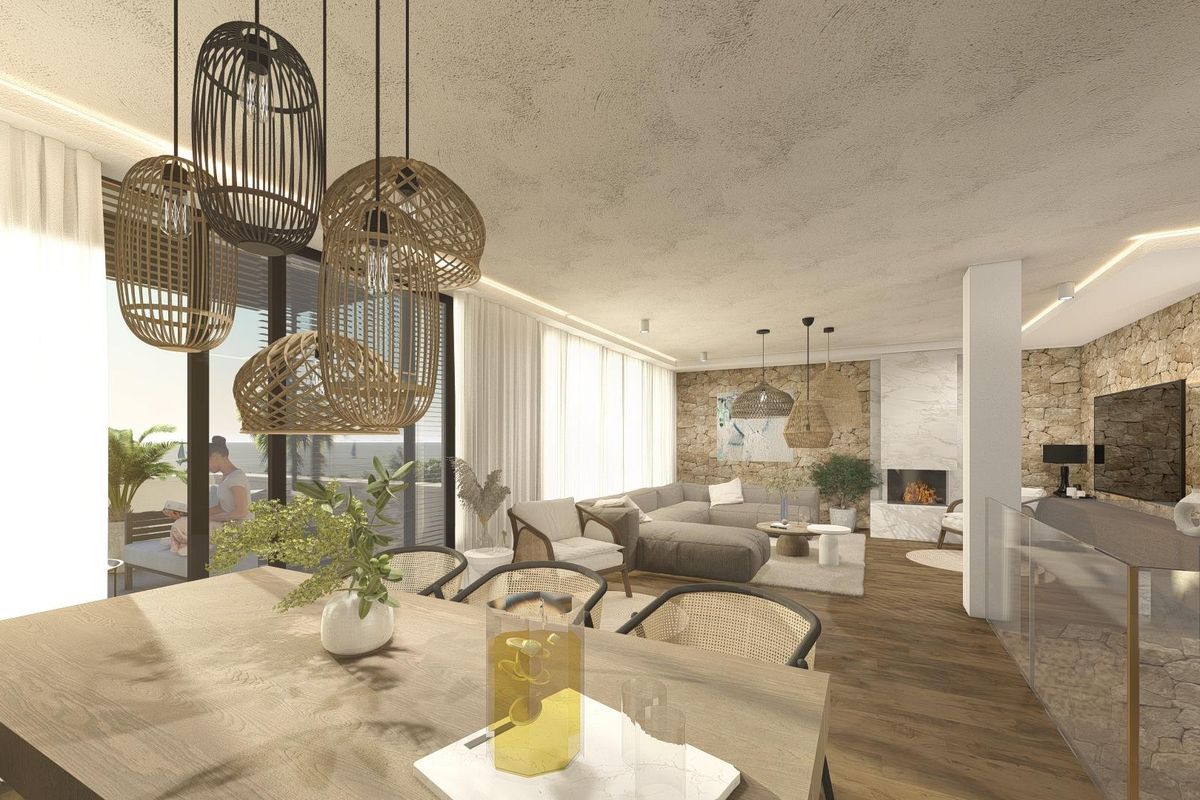 Elegante woonkamer met een gezellige zithoek en moderne decoratie in een townhouse in Altea.