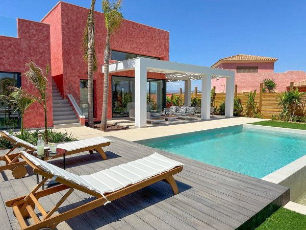 Modern 3-bed villa with pool in Cuevas Del Almanzora, featuring a stylish outdoor area and sun loungers.