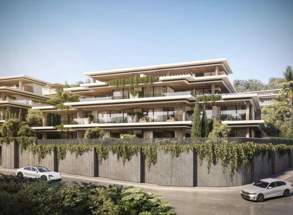 Buitenzicht op een modern 3-slaapkamer penthouse in Estepona, met weelderig groen en hedendaagse architectuur.