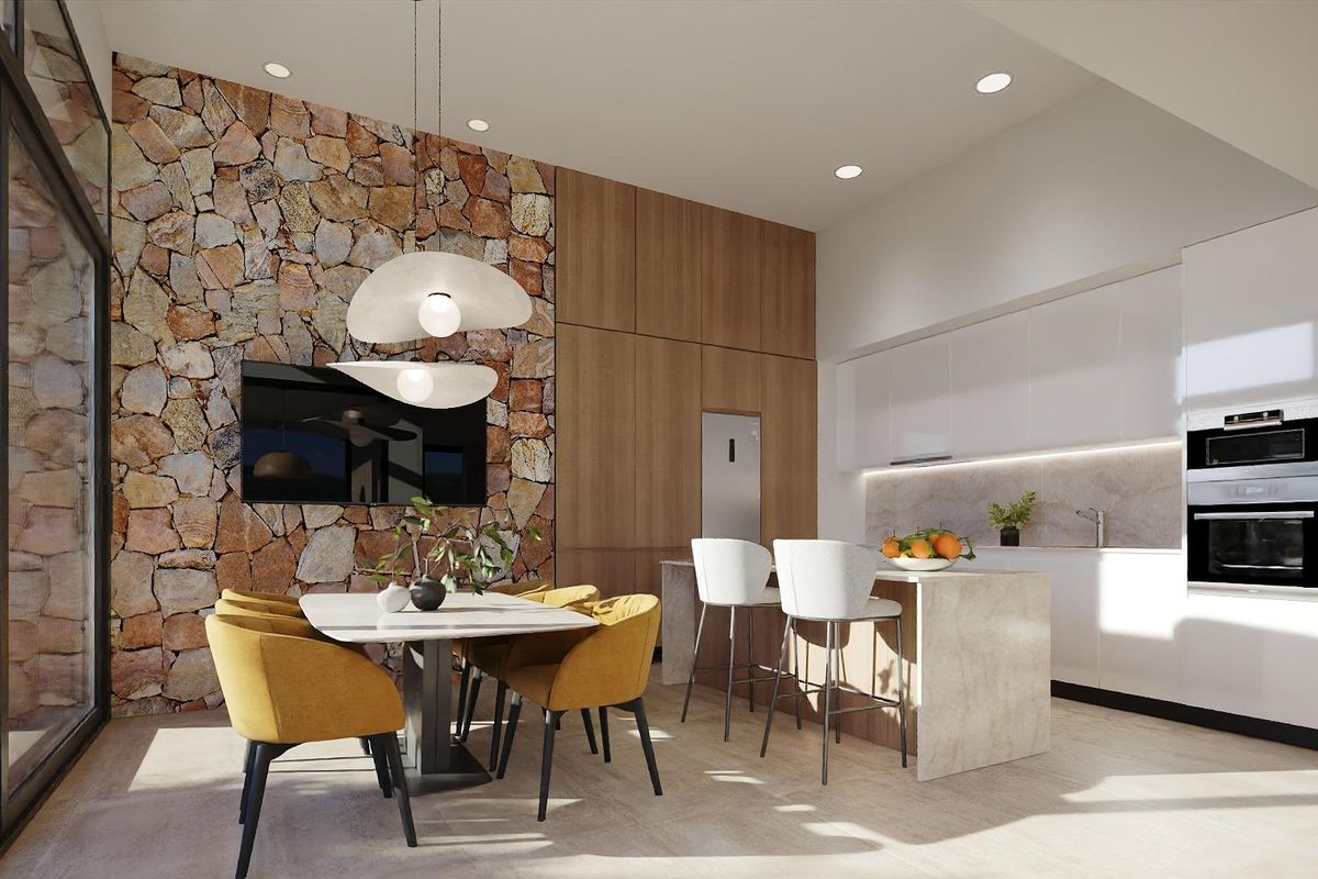 Heldere keuken met stenen accentmuur en eetruimte in een moderne villa in Fuente Álamo.