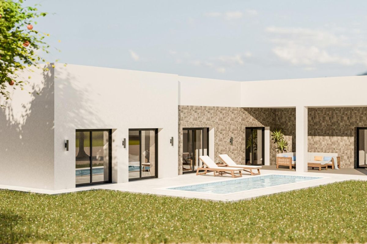 Another angle of the villa's pool area in Pinoso, surrounded by sun loungers and landscape.