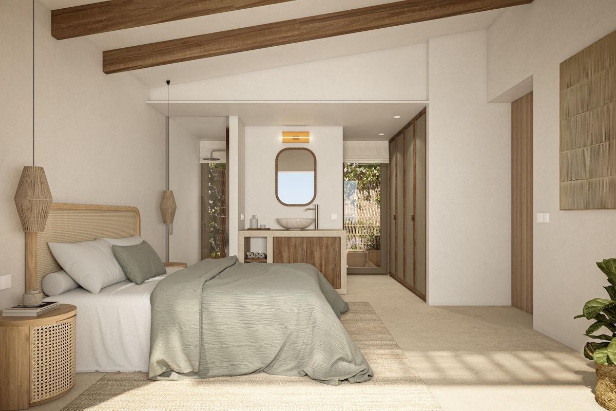 Stijlvolle slaapkamer met natuurlijke decor en ensuite badkamer in de villa gelegen in Benissa.