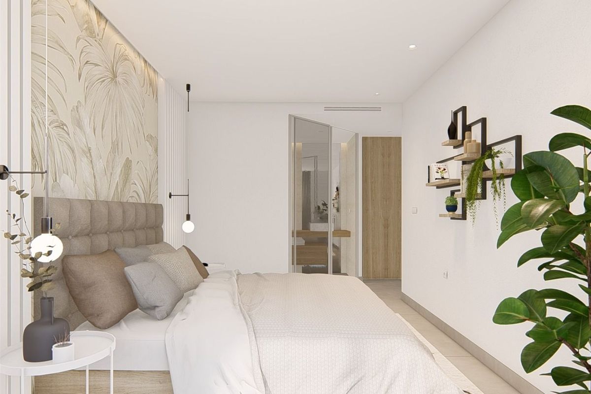 Chic bedroom arrangement featuring a cozy bed and stylish decor in a 3-bedroom apartment in Guardamar del Segura.