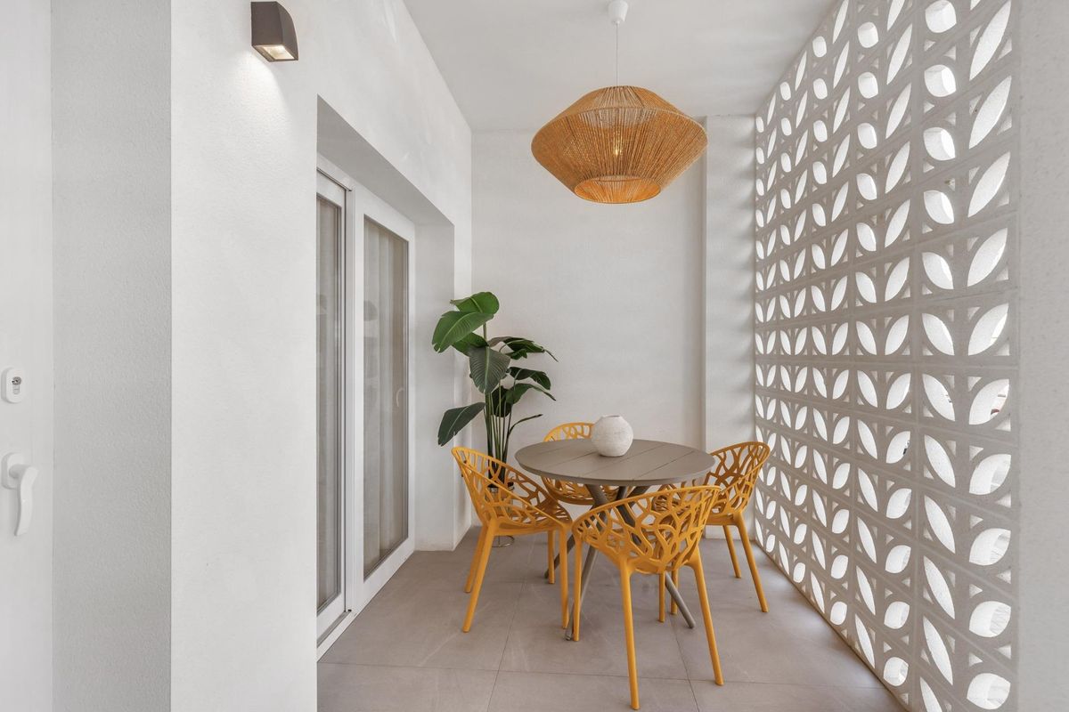 Gezellige buitenruimte met eetset, binnen het terras van het appartement op de begane grond in Torrevieja.