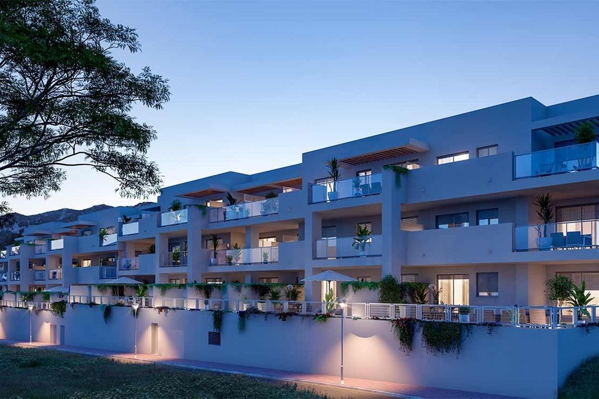 Moderne appartementen in Benalmádena met balkons, verlicht bij schemering. Kustleven aan de Costa del Sol.