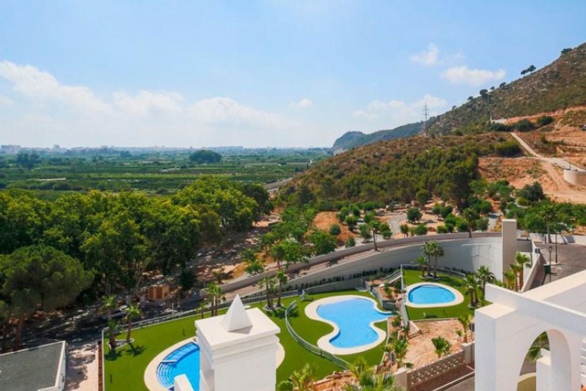 Scenisch uitzicht vanaf het terras met zwembaden en tuinen naast het appartementencomplex in Xeresa.