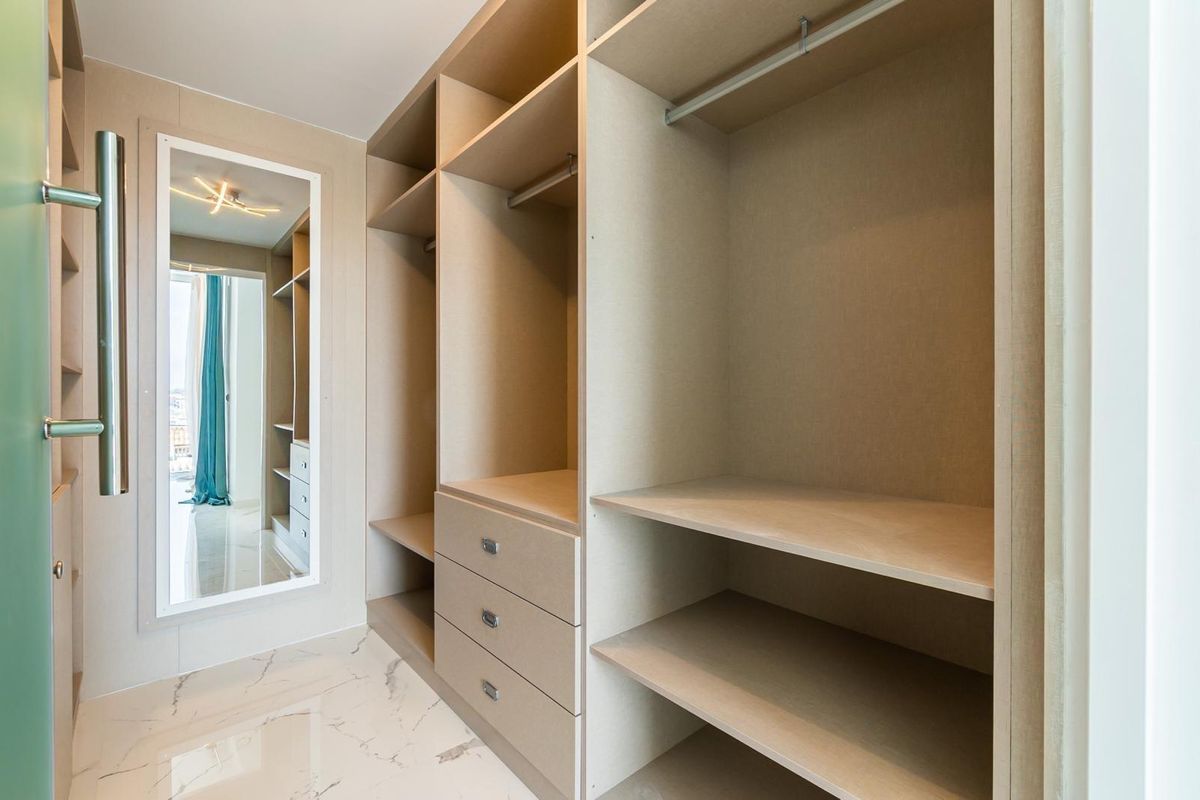 Spacious walk-in closet with ample storage and mirrors in Orihuela Costa villa.