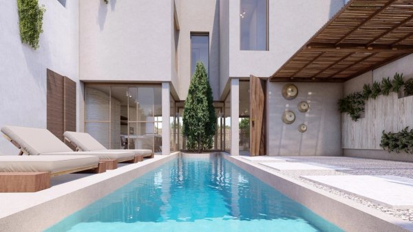 Moderne townhouse zwembadgebied in Formentera del Segura, met ligbedden naast een sprankelend zwembad.