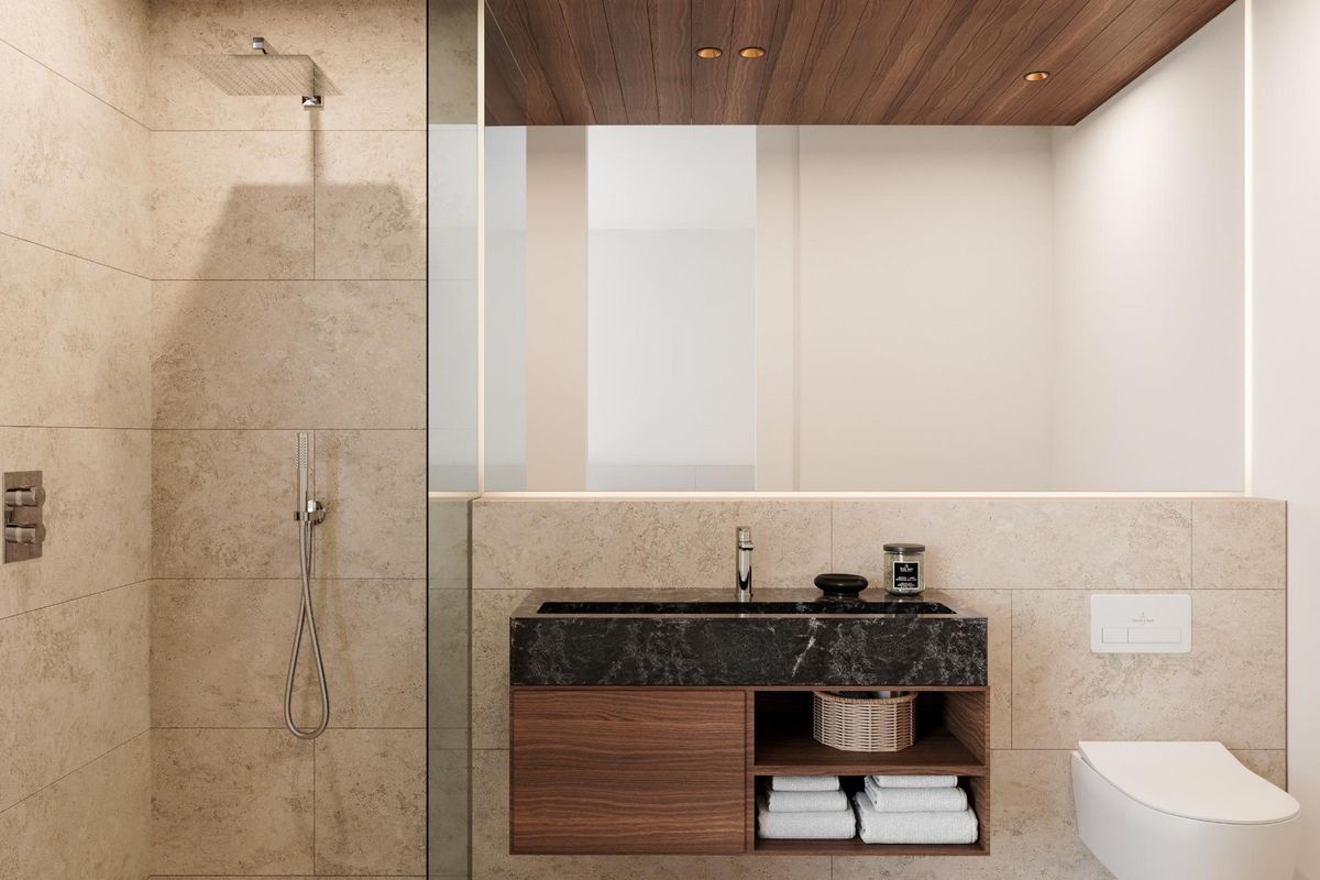 Chique badkamer met een donkere wastafel en douche, onderdeel van een eigentijds appartement in Estepona.