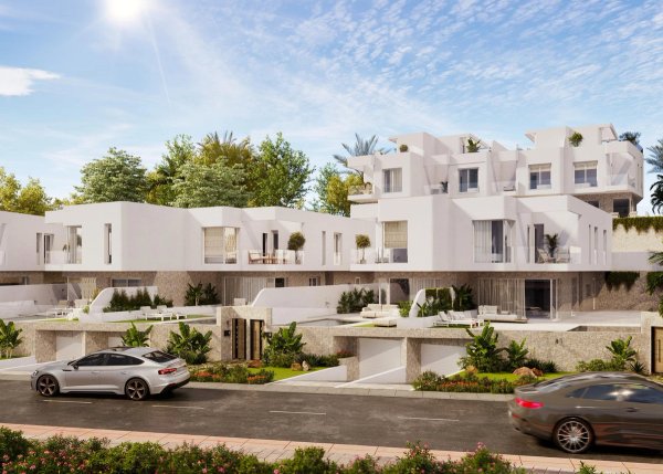 Exterieur van een moderne 3-slaapkamer townhouse in Mojacar, met tuinen en een zonnige lucht.