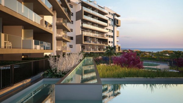 Buitenzicht op een modern 3-slaapkamer appartement in Orihuela Costa, met een rustige pool en groen.