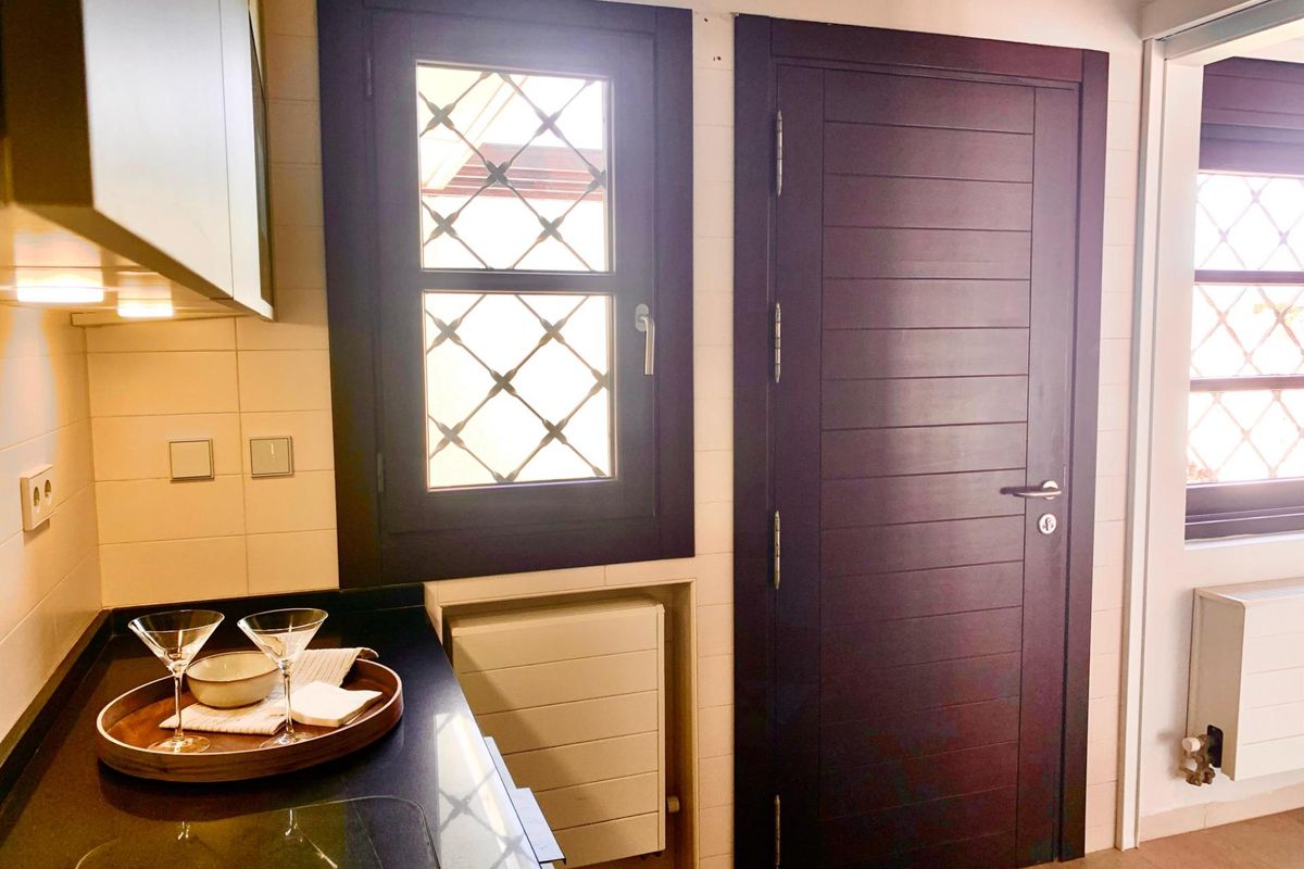 Moderne keukencorner met stijlvolle kasten en raam in Sucina, townhouse met 2 slaapkamers.