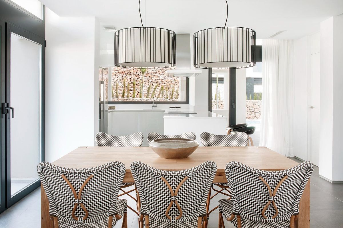 Heldere eetruimte met eigentijds meubilair en toegang tot de keuken in een villa in La Manga Club.