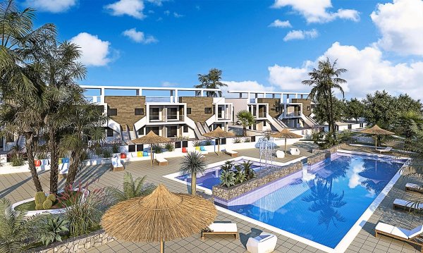 Exterior view of ground floor apartments in Pilar de la Horadada, Spain, with a communal pool and sun loungers. Landscaped gardens surround the area.
