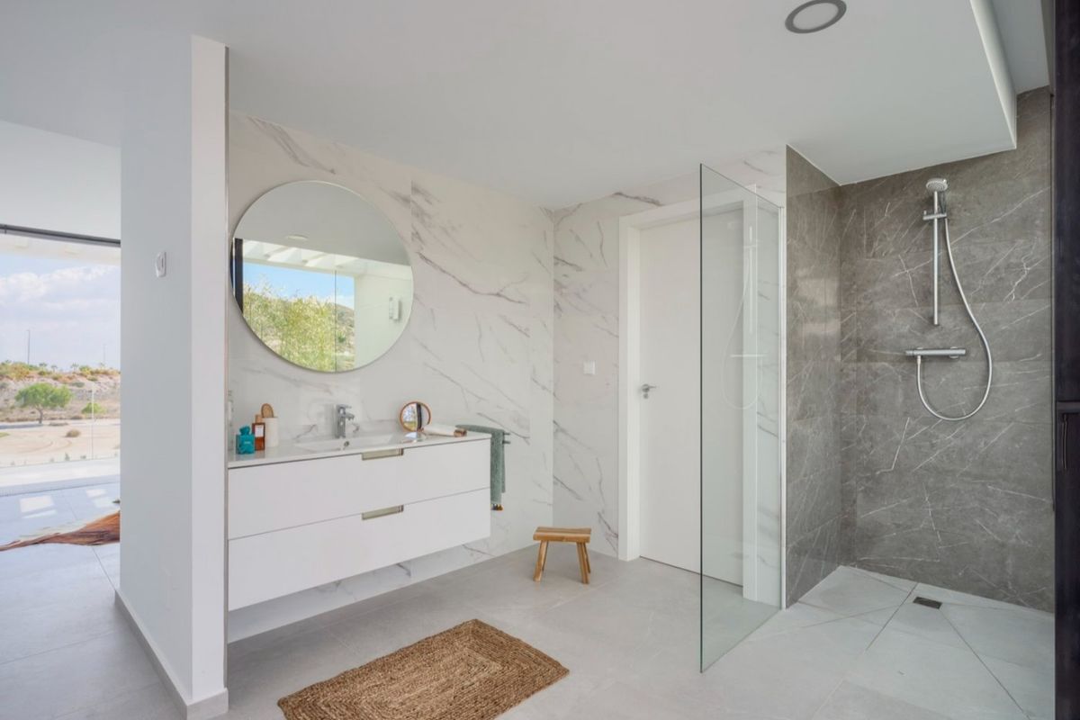 Spacious, modern bathroom featuring a walk-in shower and stylish finishes in the Baños y Mendigo villa.
