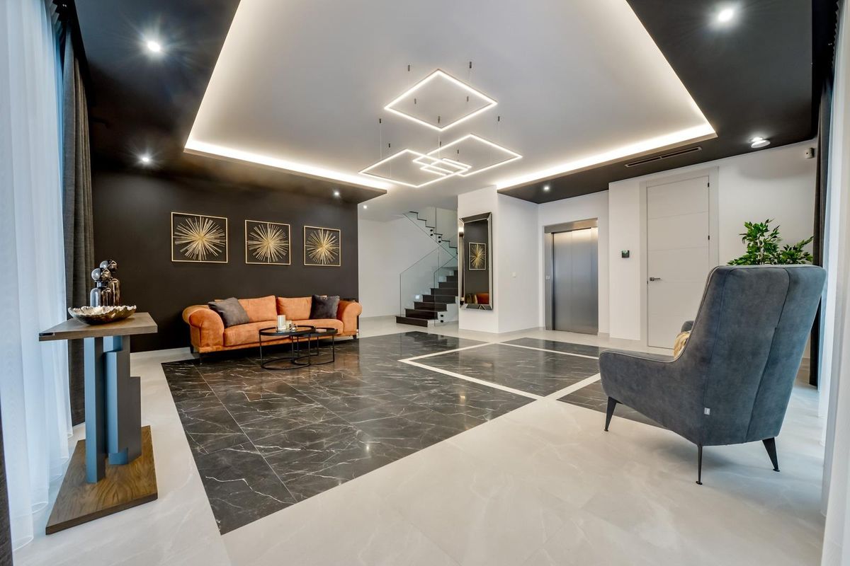 Chique zithoek in de woonkamer van de villa in Finestrat, versierd met moderne kunst en gezellige texturen.