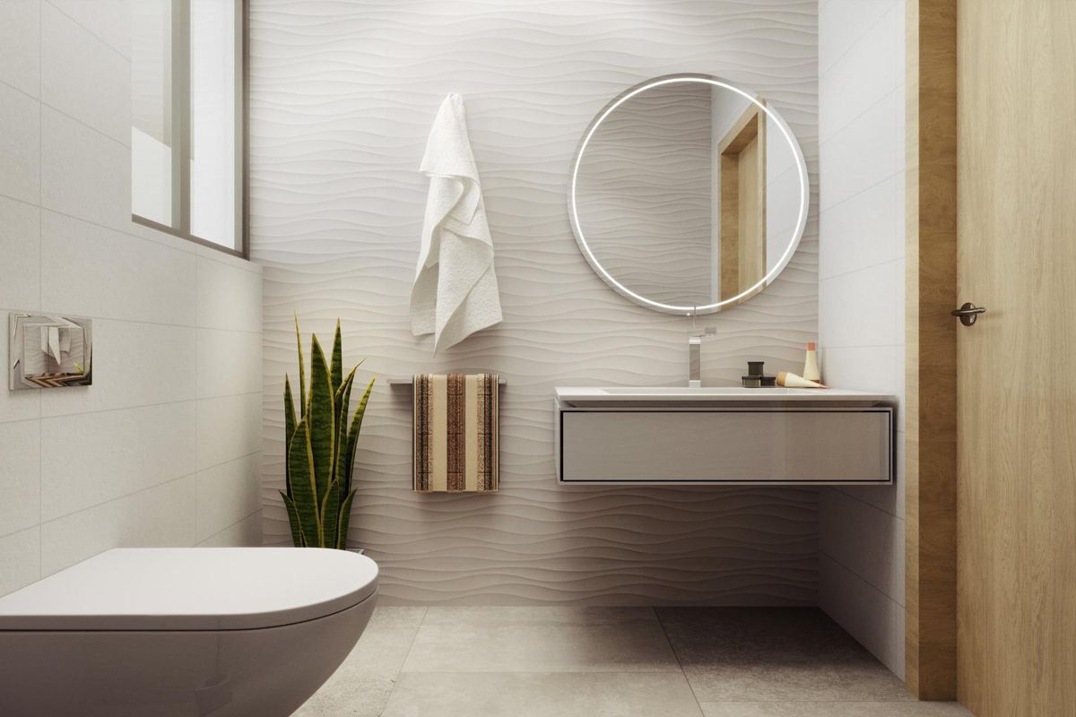 Moderne badkamer met een strakke inrichting en cirkelvormige spiegel in een 4-slaapkamer villa in Rojales, Costa Blanca Zuid.