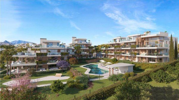 Buitenzicht op een modern appartementengebouw met 3 slaapkamers in Estepona, omgeven door tuinen en een zwembad.