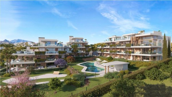 Buitenzicht op een modern appartementengebouw met 3 slaapkamers in Estepona, omgeven door tuinen en een zwembad.