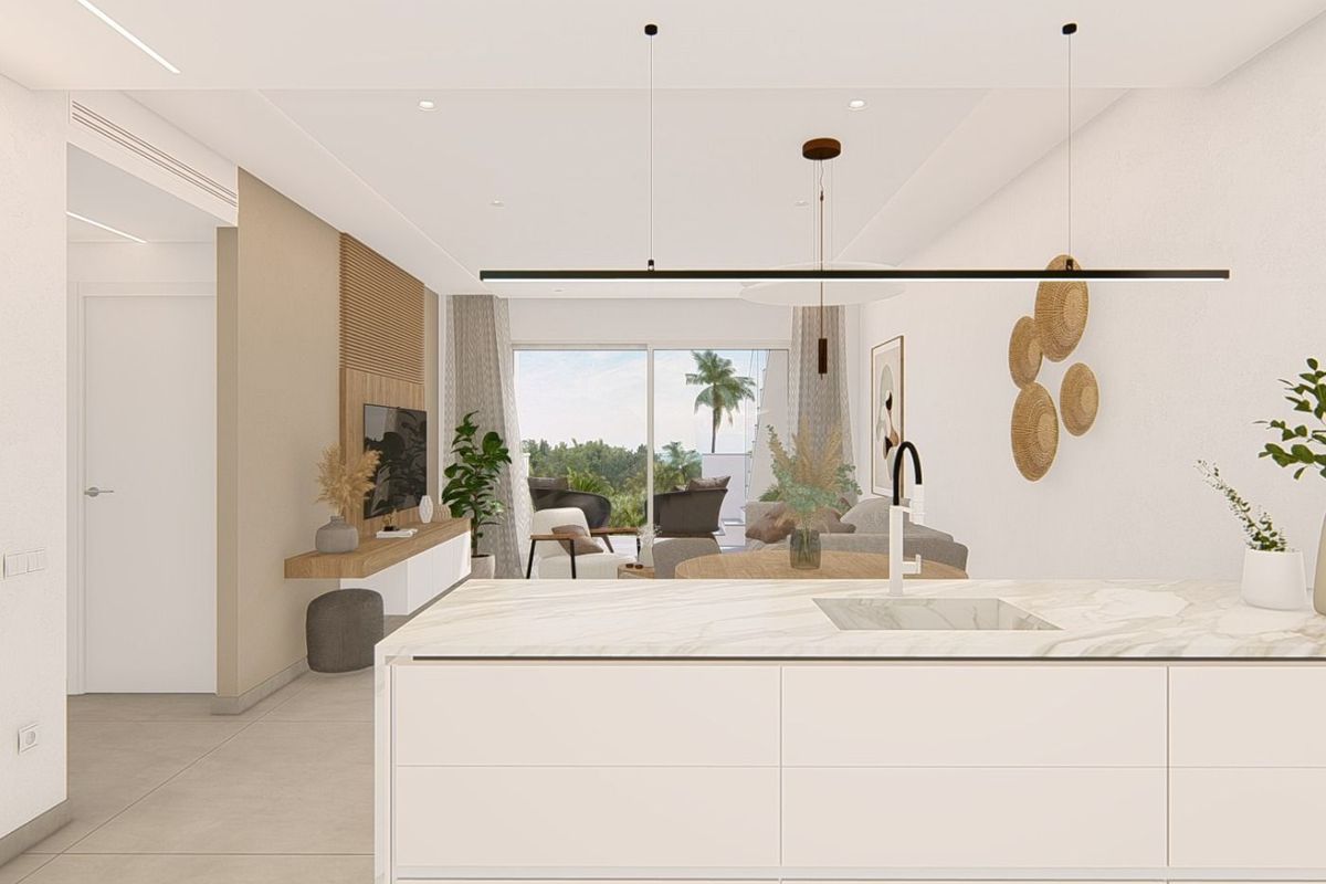 Open kitchen view with modern decor and lounge area, showcasing a 3-bed apartment in Guardamar del Segura.