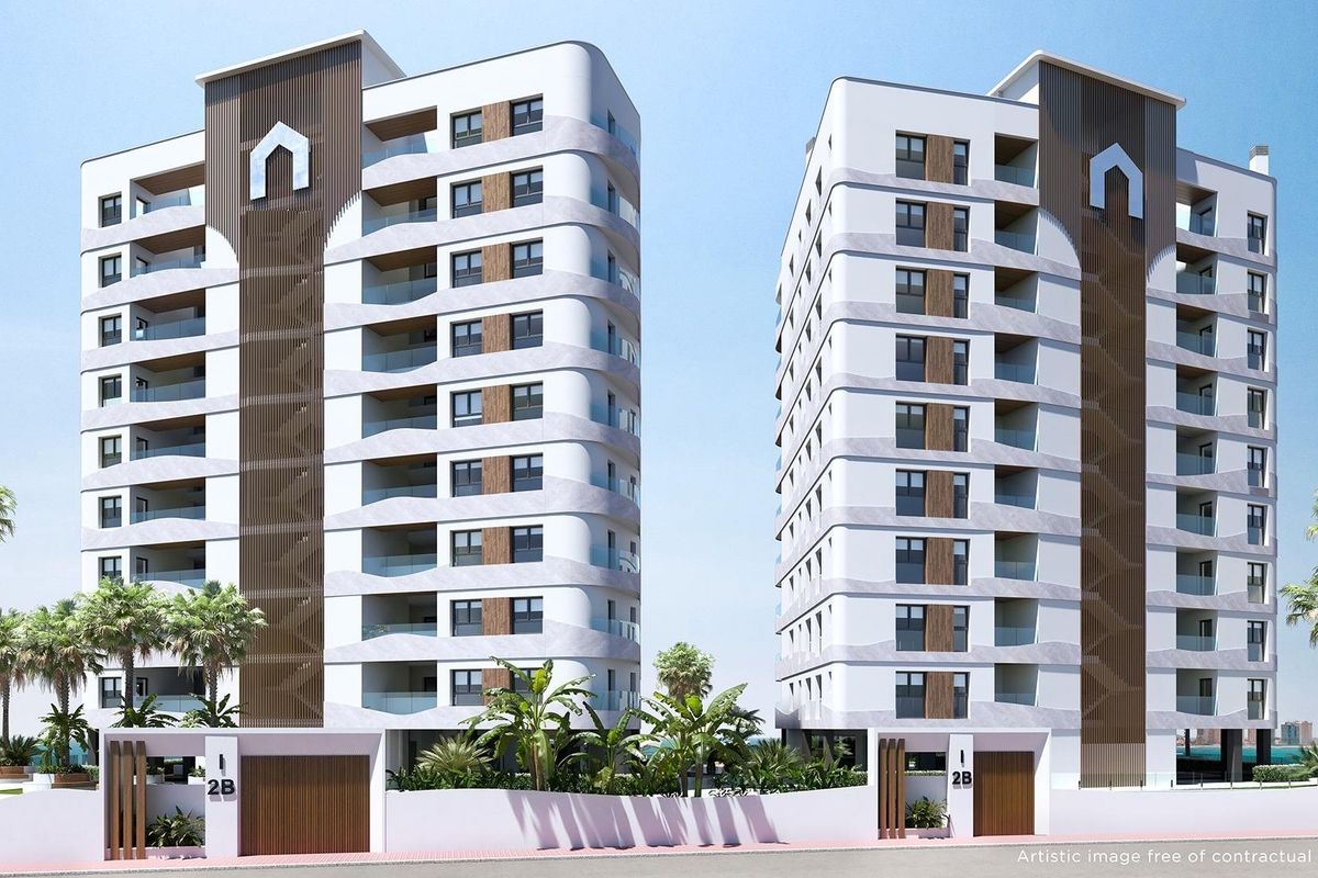 Panoramic view of La Manga del Mar Menor, featuring buildings along the shoreline and stunning blue water.