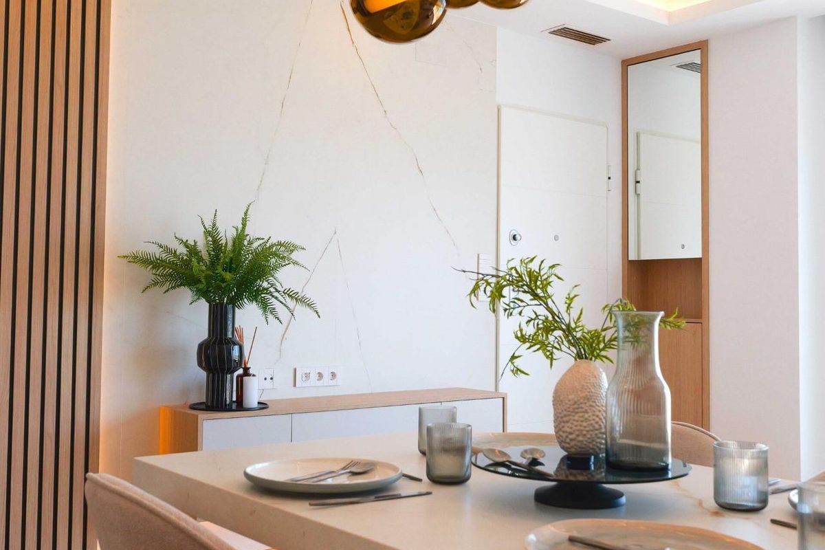 Stylish dining setup with greenery and decor in a modern apartment, La Manga del Mar Menor, Spain.