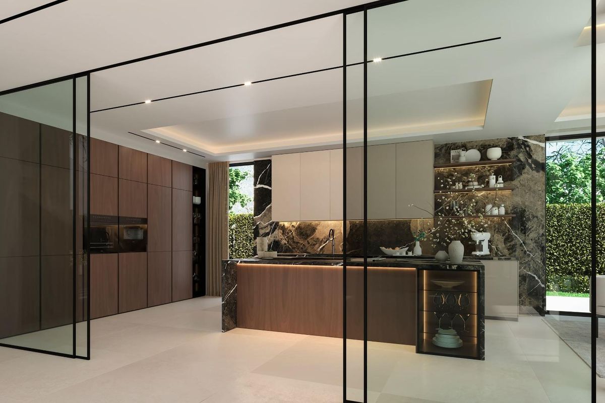 Ruime keuken in een villa in estepona met een donkere marmeren achterwand. glazen deur leidt naar buiten. eiland met houten panelen.