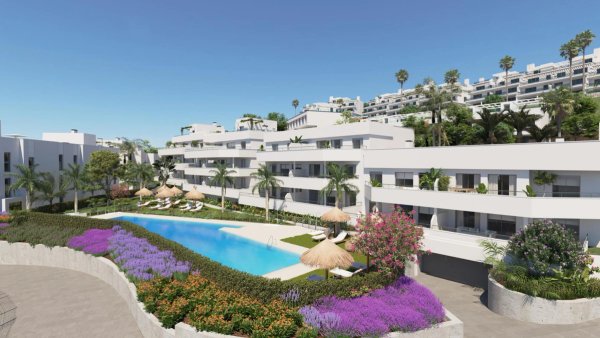Buitenzijde van een modern appartementencomplex in Estepona, met een zwembad omringd door weelderige tuinen.