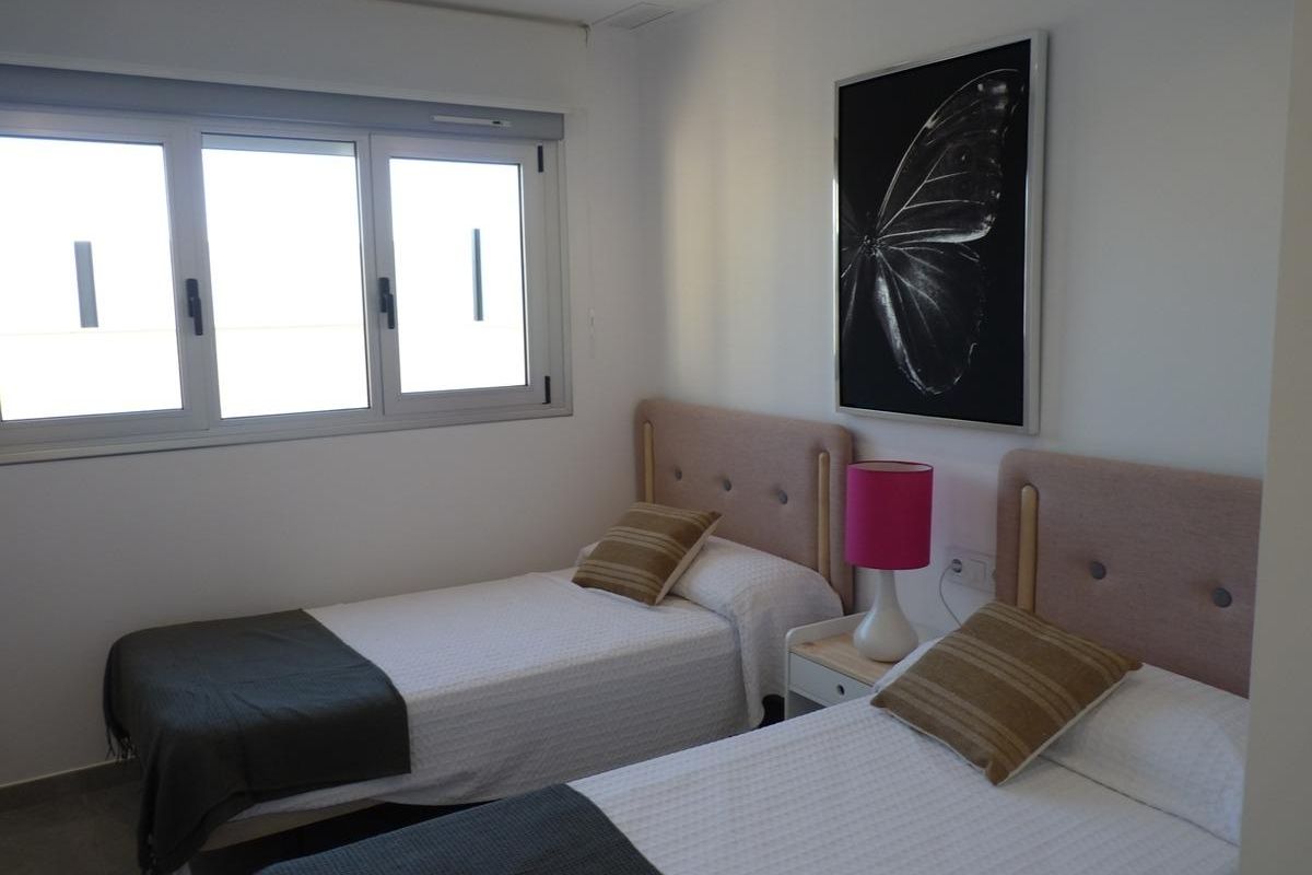 Eenvoudige maar moderne slaapkamer met twee bedden in een town house in Pilar de La Horadada, Costa Blanca Zuid.