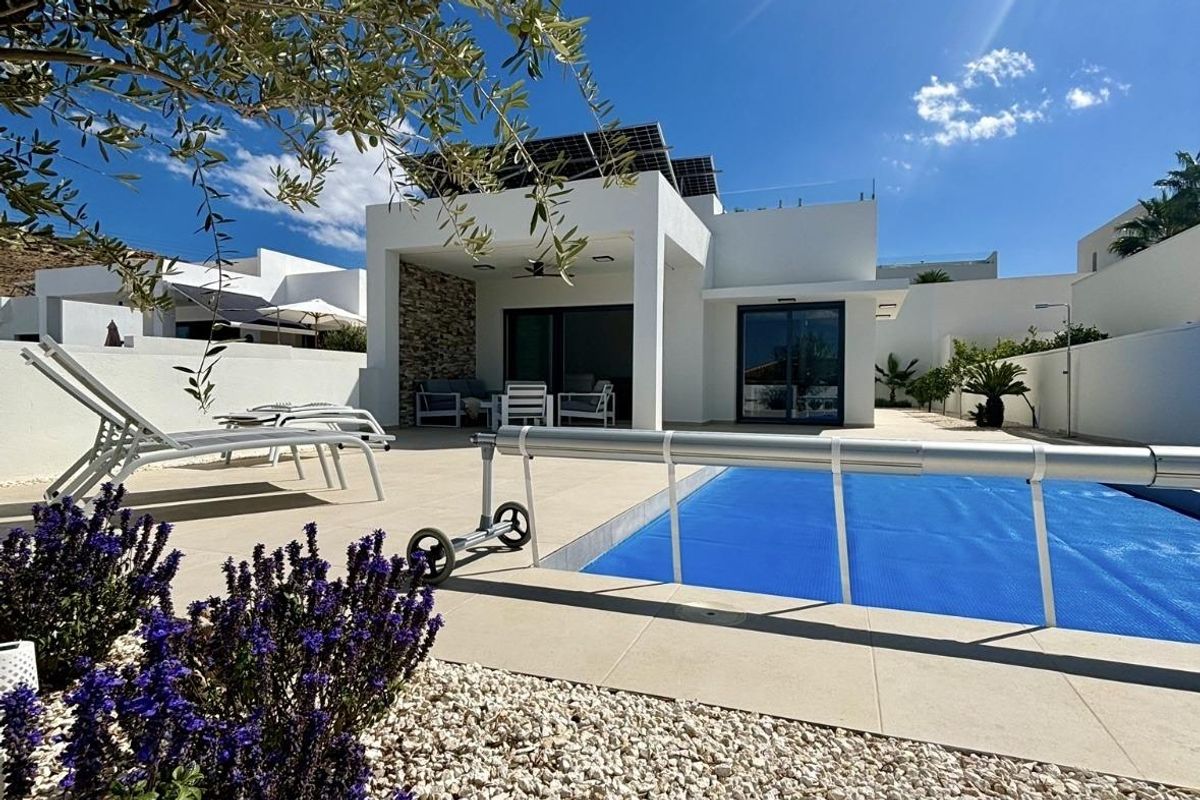 Close-up van het zwembad van de villa in Benijofar, omringd door bloeiende bloemen en modern ontwerp.