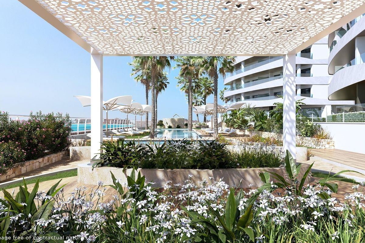 Landscaped garden area with a modern gazebo in La Manga del Mar Menor, part of a 1-bed apartment complex.