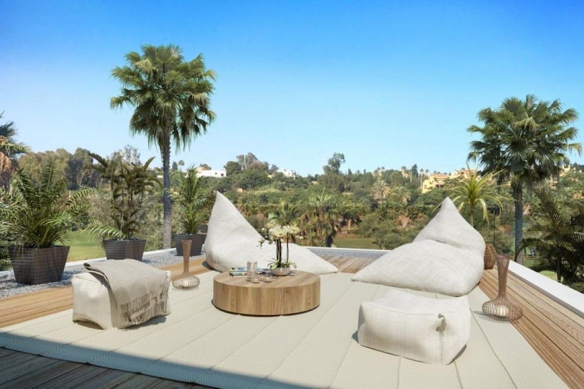Charmante terrassengebied met zitplaatsen in een 4-slaapkamer villa, met uitzicht op het weelderige landschap van Estepona.